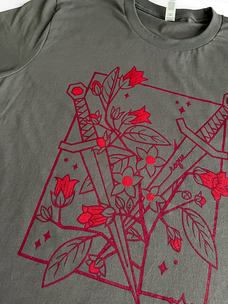 Close up of red Rogue Floral Classic tee on a grey tshirt