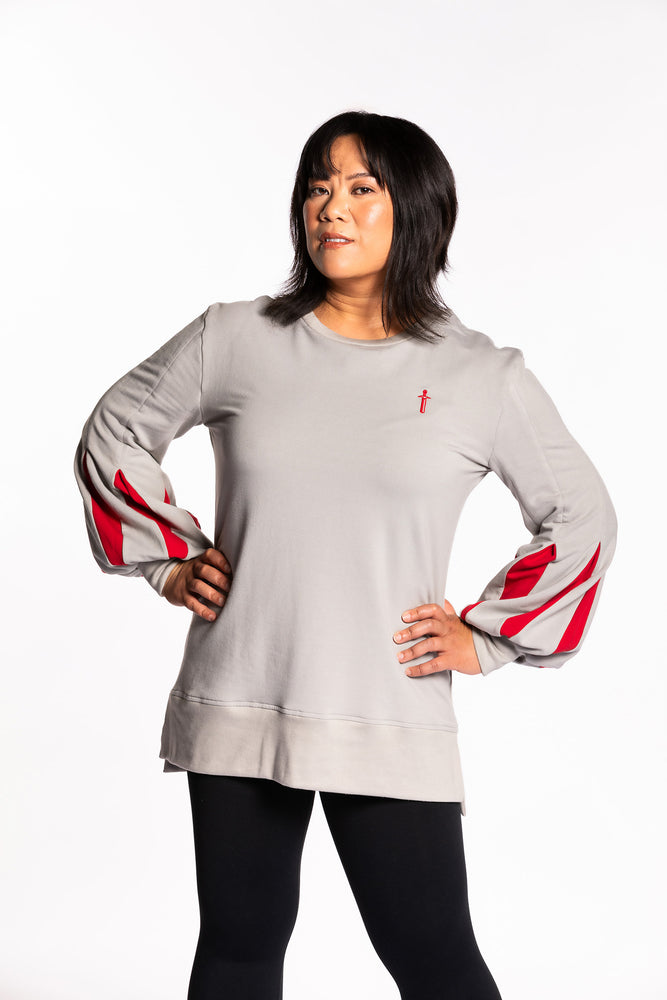 Cheryll wearing the Fighter Shield Pullover - Silver/Ruby. Cheryll is wearing a medium. Her measurements are a 40" Bust, 32" Waist, and 40" Hips, and she is 5'4.5"