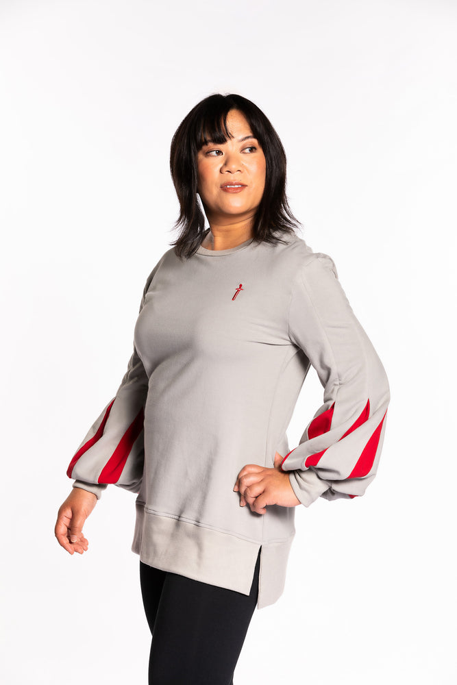Cheryll wearing the Fighter Shield Pullover - Silver/Ruby. Cheryll is wearing a medium. Her measurements are a 40" Bust, 32" Waist, and 40" Hips, and she is 5'4.5"