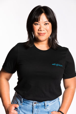 Cheryll is wearing the Fighter CLASSic Embroidered Unisex Tee - Black/Teal in a medium