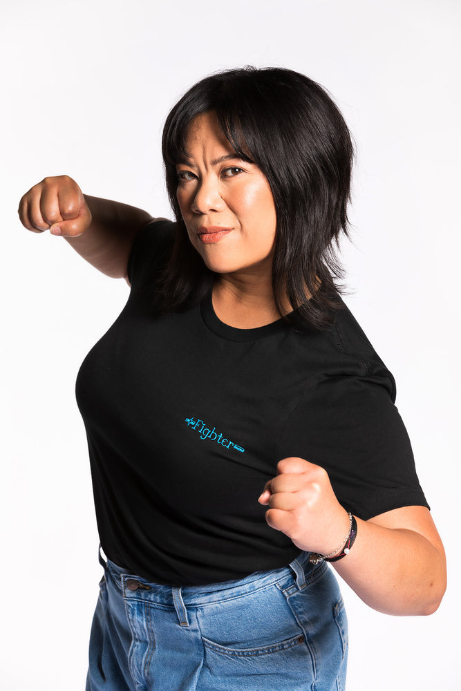 
            
                Load image into Gallery viewer, Cheryll is wearing the Fighter CLASSic Embroidered Unisex Tee - Black/Teal in a medium
            
        