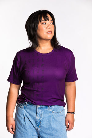Cheryll wearing the Guild Party Logo Unisex Tee - Purple/Black. Cheryll is wearing a medium. Her measurements are a 40" Bust, 32" Waist, and 40" Hips, and she is 5'4.5"