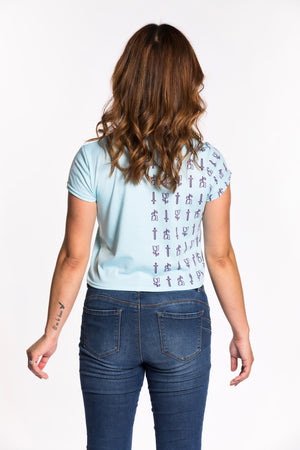 Chelsea wearing the Guild Party Logo Crop Tee - Mint/Purple back view. Chelsea is wearing an extra small. Her measurements are 36" Bust, 29" Waist, and 39" Hips, and she is 5'4".