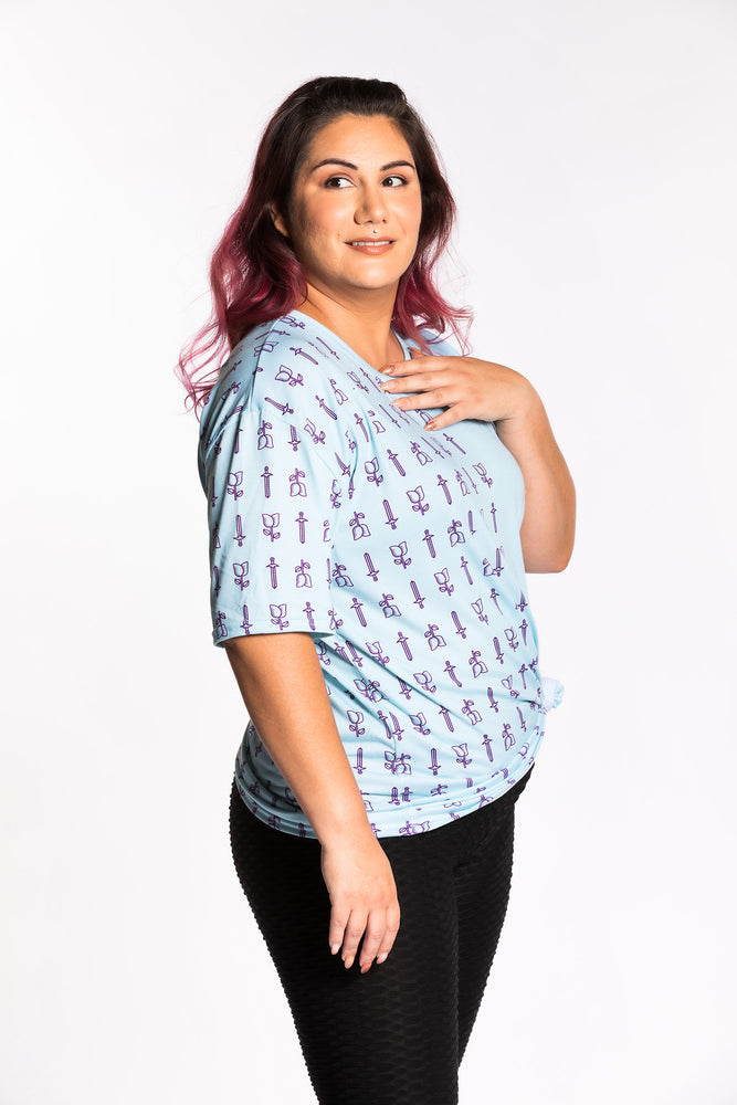 Jessica wearing the Guild Party Logo Unisex Tee - Mint/Purple side view. Jessica is wearing an extra large. Her measurements are a 47" Bust, 37" Waist, and 46" Hips, and she is 5'6"