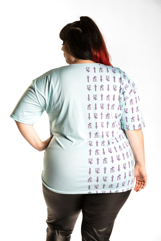 Katie Lynn wearing the Guild Party Logo Unisex Tee - Mint/Purple back view. Katie Lynn is wearing a 2X. Her measurements are a 49" Bust, 40" Waist, and 53" Hips, and she is 5'8"